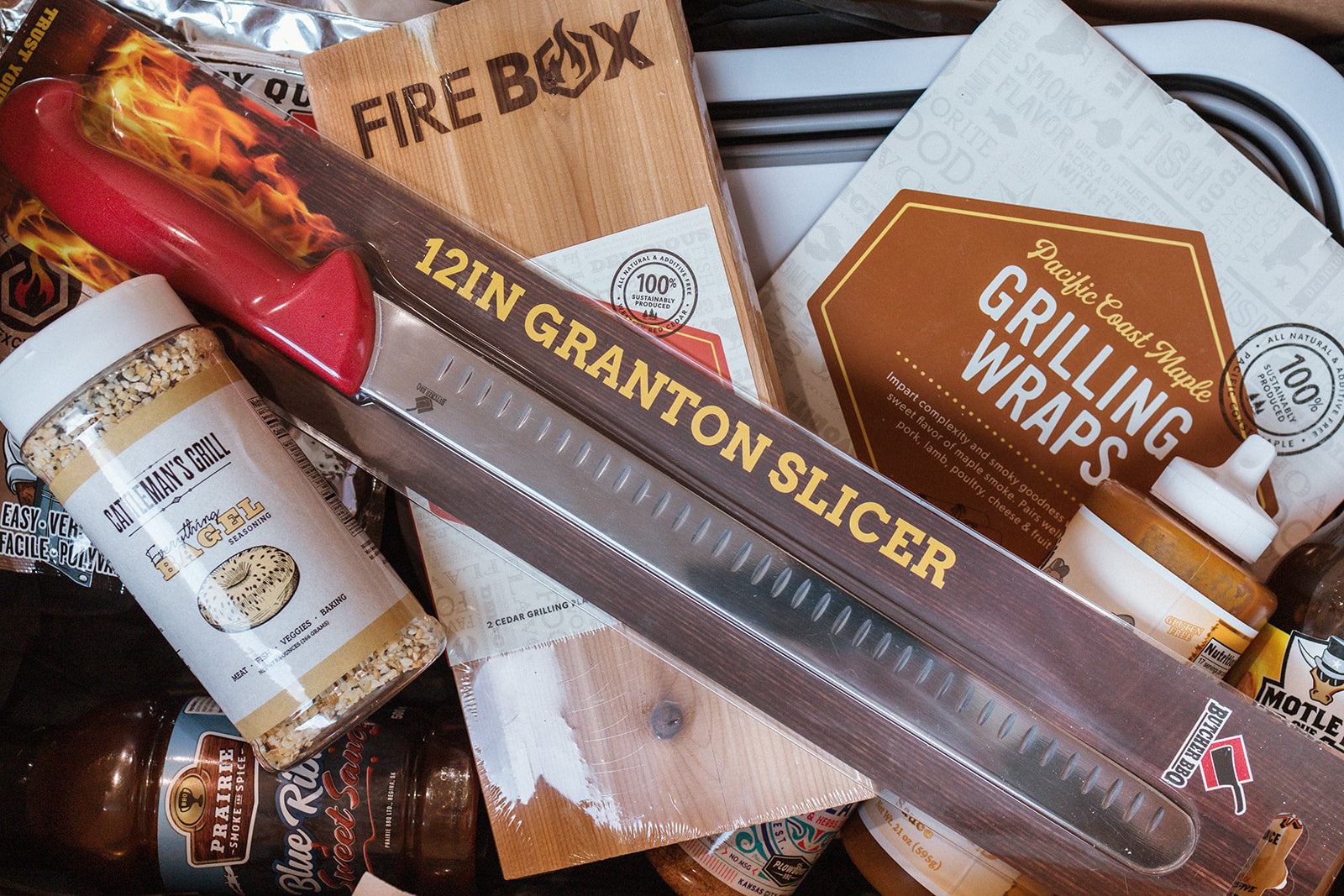 Pictured - Maple Grilling wraps, cedar grilling planks, 12in slicing knife, bbq sauces and rubs